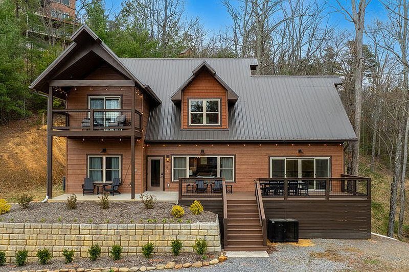 Daylight three-quarter view of the log home at 4228 Wears Valley Road